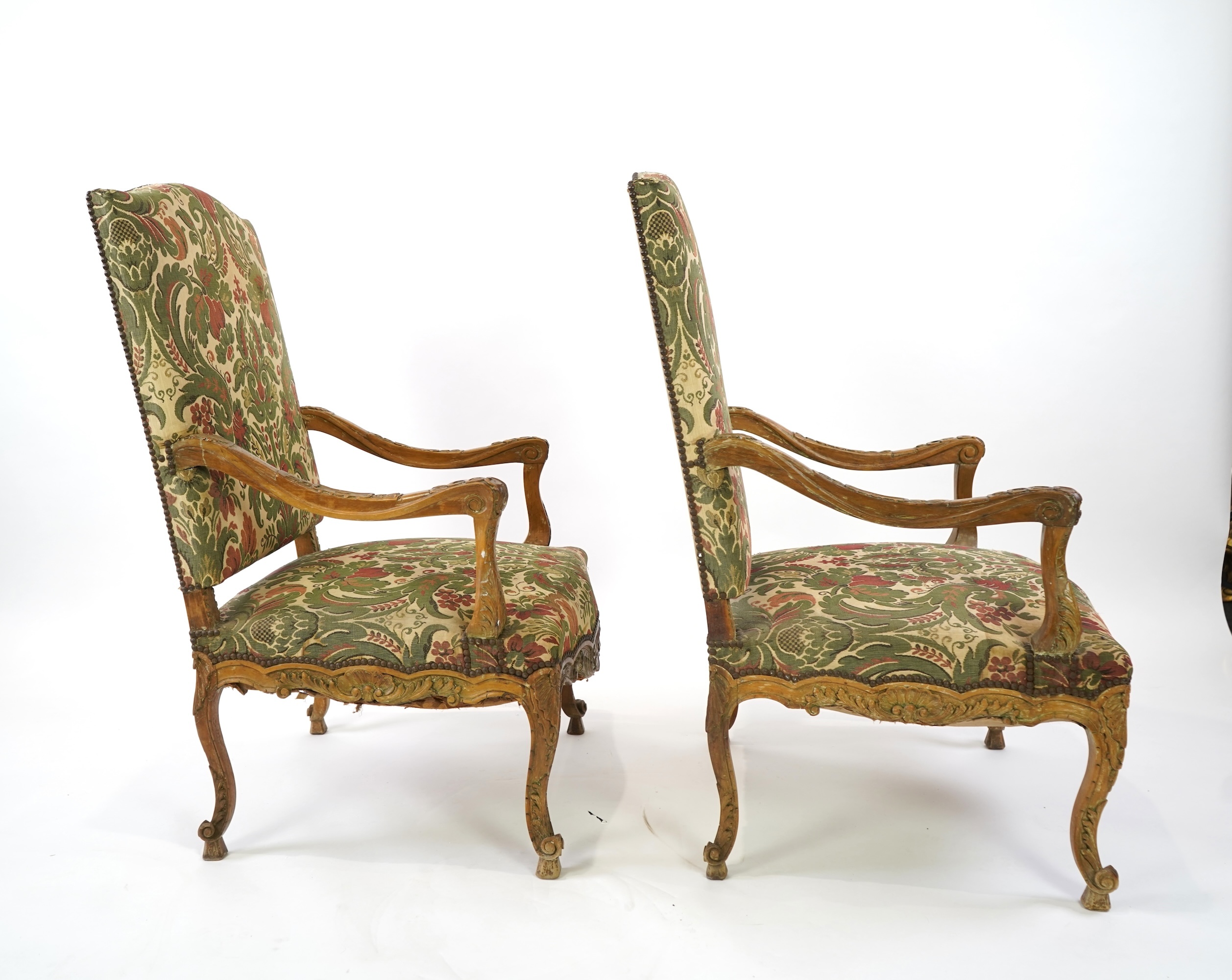 A pair of 19th century Louis XV style carved walnut grand fauteuil, with machined polychrome floral upholstery, outswept arms on cabriole legs, 74cm wide, 66cm deep, 116cm high, Provenance: The late Kenneth Turner (1936-